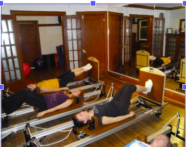 people lying on reformers with jumpboards