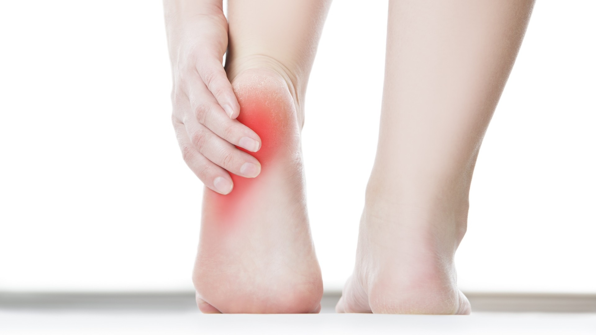 feet with highlighted area where plantar fasciitis is