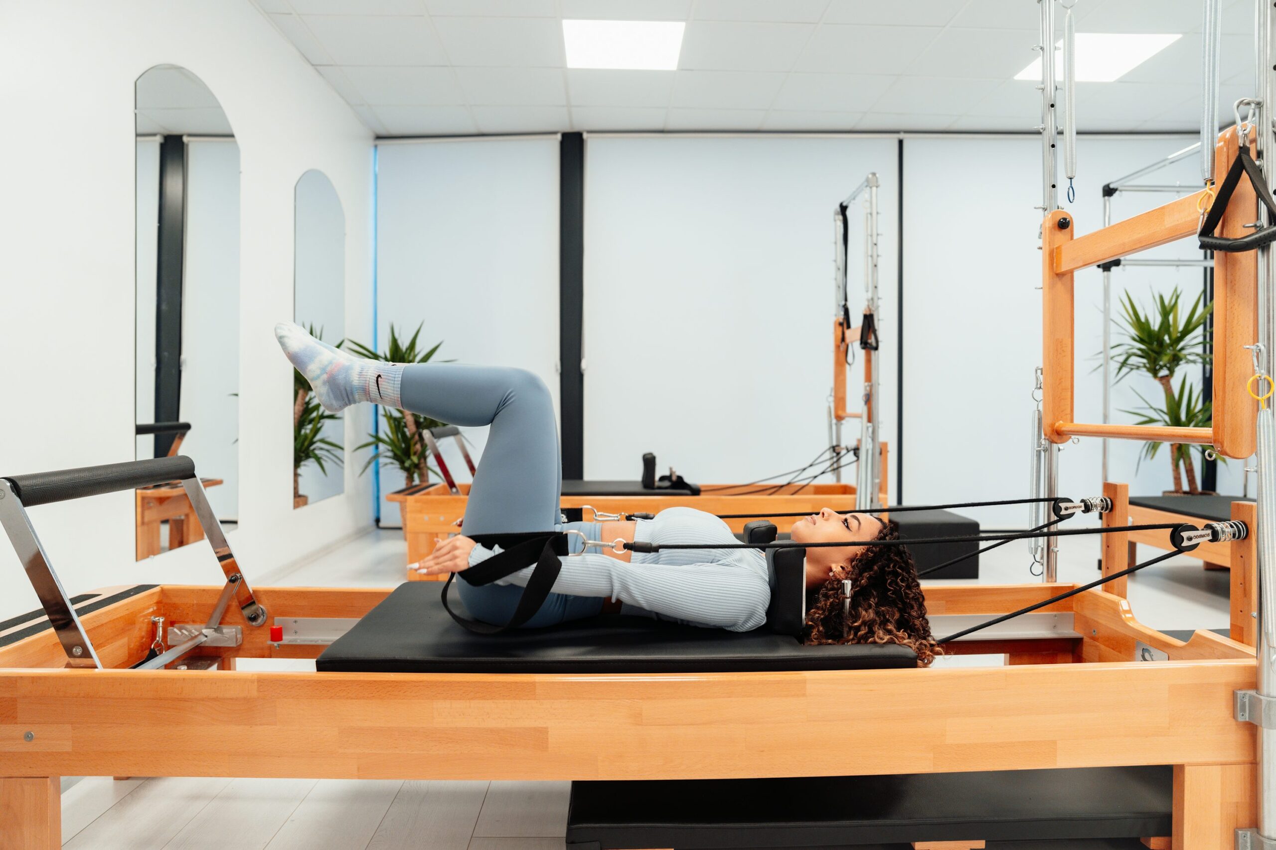 woman on a reformer doing Pilates