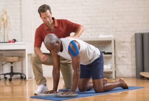 pilates instructor and client on hand and knees on the mat
